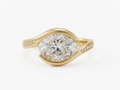 Direct top view of a 3 carat East-West horizontally set oval lab grown diamond ring in yellow gold with pavé details.