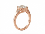 Side profile view of a rose gold 3 CT oval cut lab grown diamond bezel engagement ring with pave diamond details.