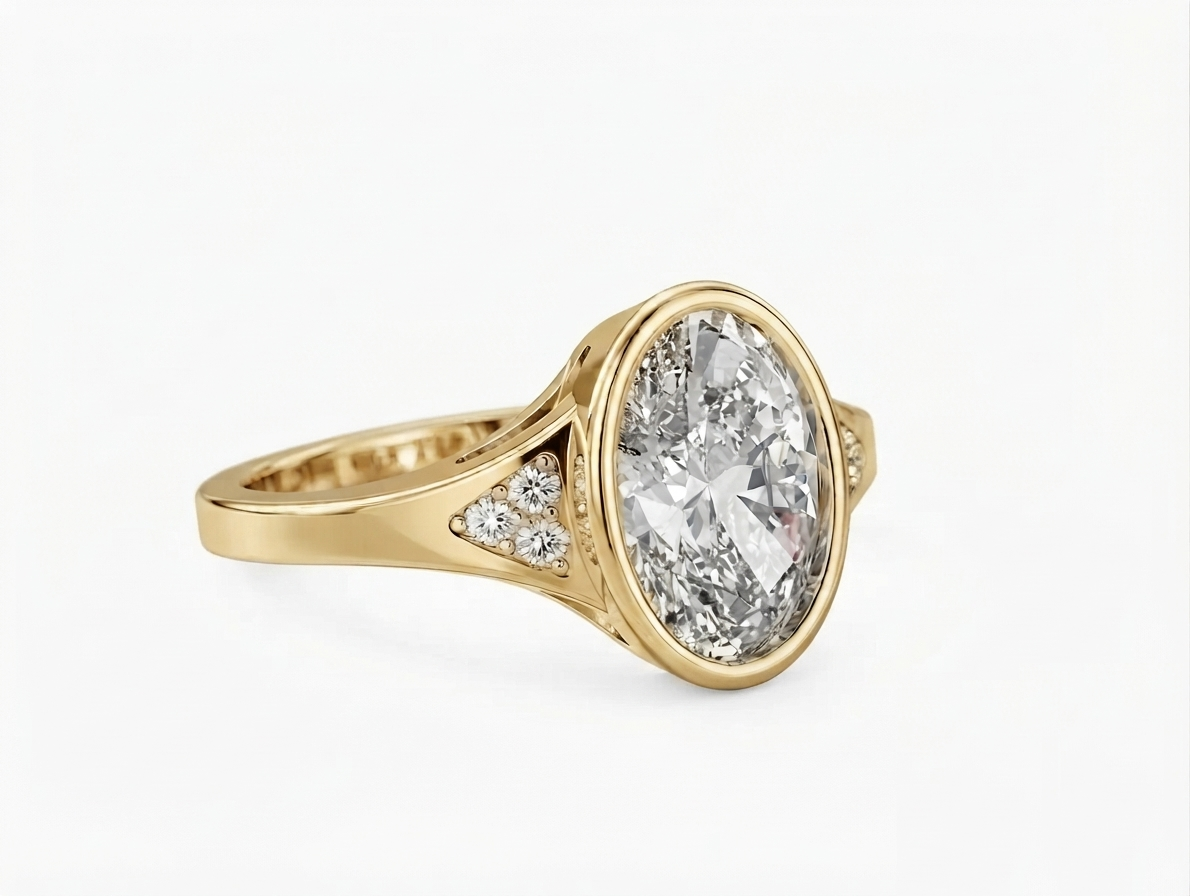 Three-quarter view of a 3 carat oval lab diamond set in a yellow gold bezel ring with triangular pave accent shoulders.
