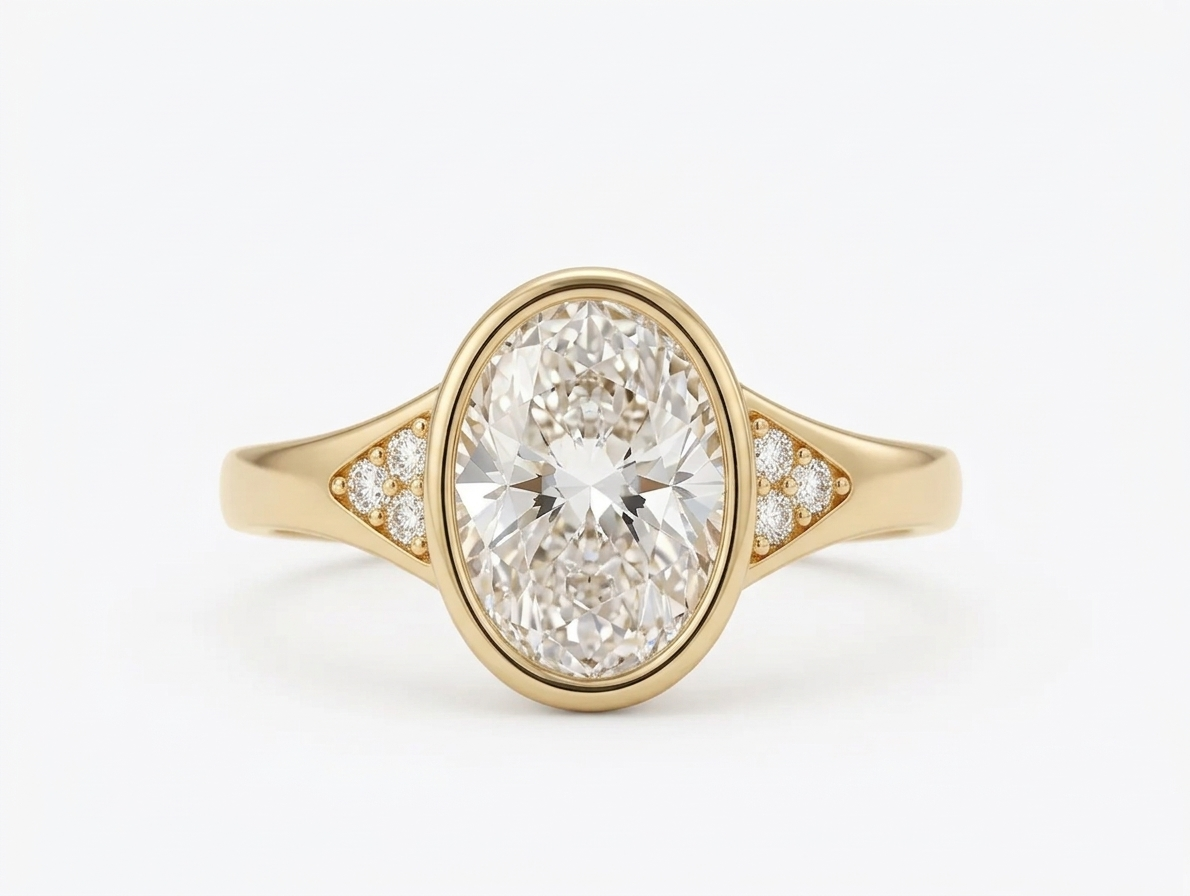Top-down view of a 3 CT oval lab grown diamond set in a yellow gold full bezel ring with pave cluster band accents.