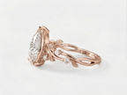 Side profile showing the intricate leaf and vine band of a rose gold 3 carat pear lab diamond ring.