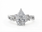 Top view of a 3 CT pear cut lab grown diamond nature inspired ring with a white gold botanical leaf band.