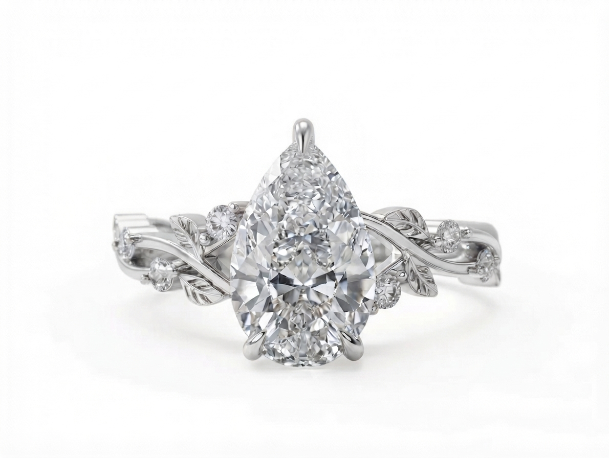 Top view of a 3 CT pear cut lab grown diamond nature inspired ring with a white gold botanical leaf band.