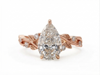 Direct top view of a 3 CT pear cut lab grown diamond set on a rose gold organic vine band.