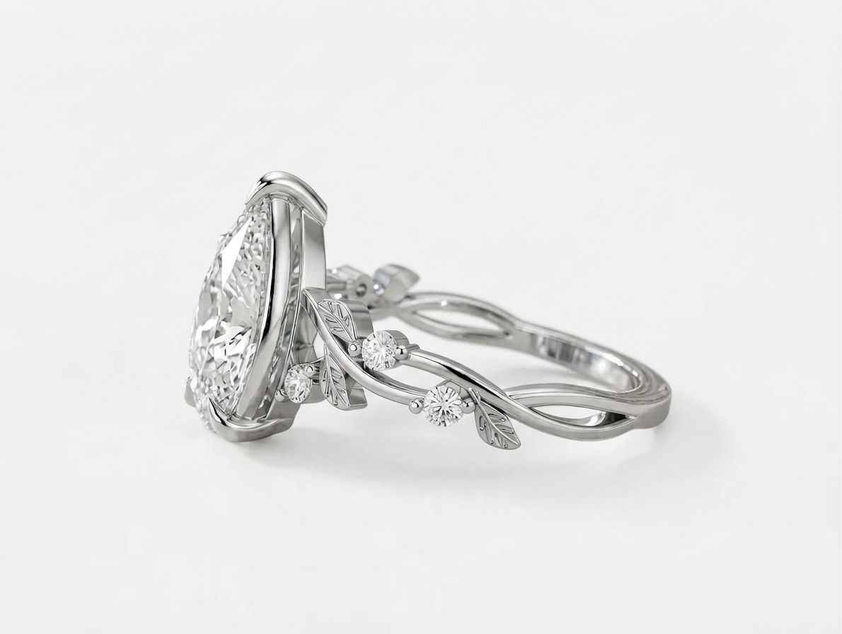 Side angle view of a white gold botanical vine engagement ring featuring a 3 CT pear cut lab grown diamond.