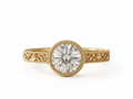 Top view of a 3 CT round lab grown diamond engagement ring in yellow gold with beaded milgrain bezel.