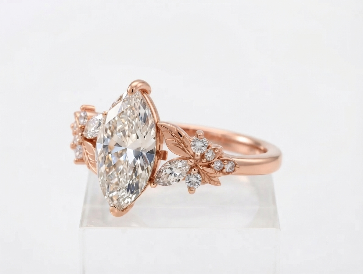 Side profile view of a rose gold 3 CT marquise cut lab grown diamond engagement ring with leaf engraving.