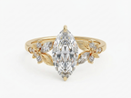 Top-down view of a 3 carat marquise cut lab grown diamond floral engagement ring in yellow gold.