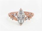 Top-down perspective of a rose gold 3 CT marquise lab grown diamond engagement ring with floral accents.