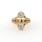 Top view of a two stone round cut lab grown diamond engagement ring with bezel settings in yellow gold.