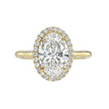 Top view of a yellow gold 3 CT oval lab diamond engagement ring with diamond halo.