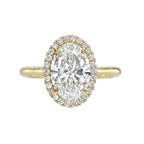 Top view of a yellow gold 3 CT oval lab diamond engagement ring with diamond halo.