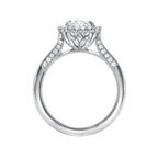 Side profile view of a white gold 3 CT oval lab grown diamond engagement ring with carved lotus basket.