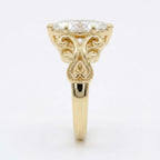 Profile view of a yellow gold 4 CT marquise lab grown diamond ring showing vintage scrollwork detail.