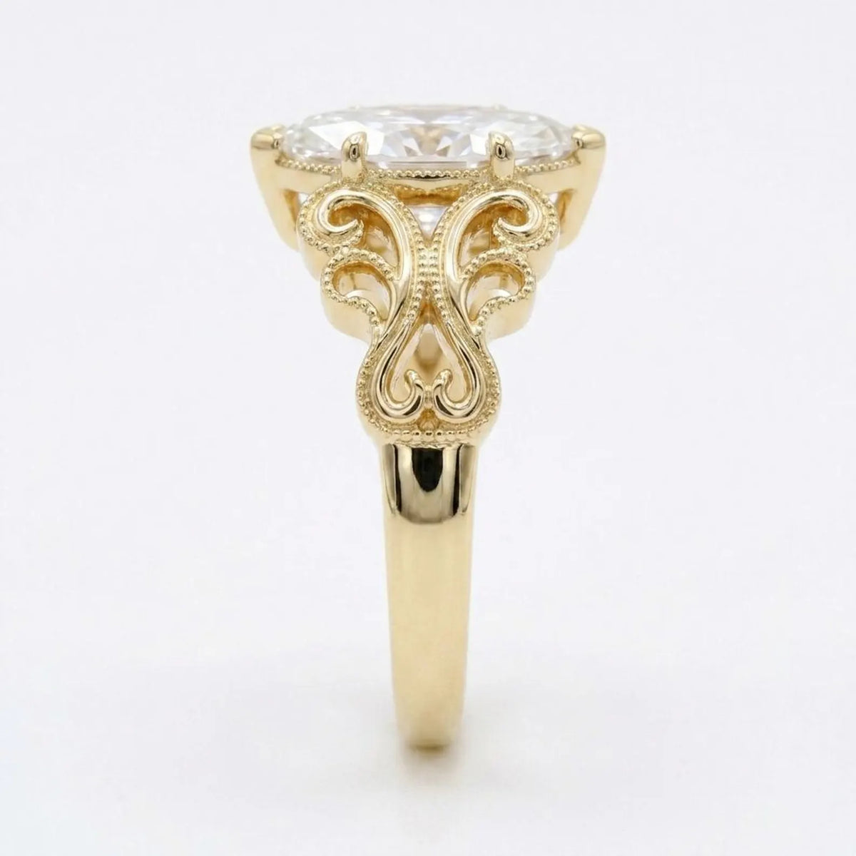 Profile view of a yellow gold 4 CT marquise lab grown diamond ring showing vintage scrollwork detail.