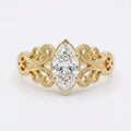 Top-down view of a 4 CT marquise cut lab grown diamond engagement ring with ornate filigree shoulders in yellow gold.