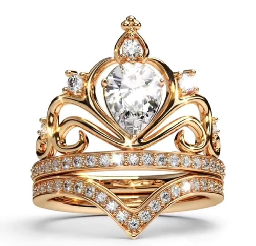Front view of a 1.5 CT pear cut lab grown diamond crown tiara ring set with matching chevron pavé band in yellow gold.