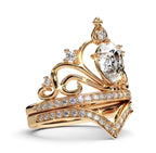 Alternate side-angle view showing the pear-cut center stone held in an ornate crown basket with matching pavé band.
