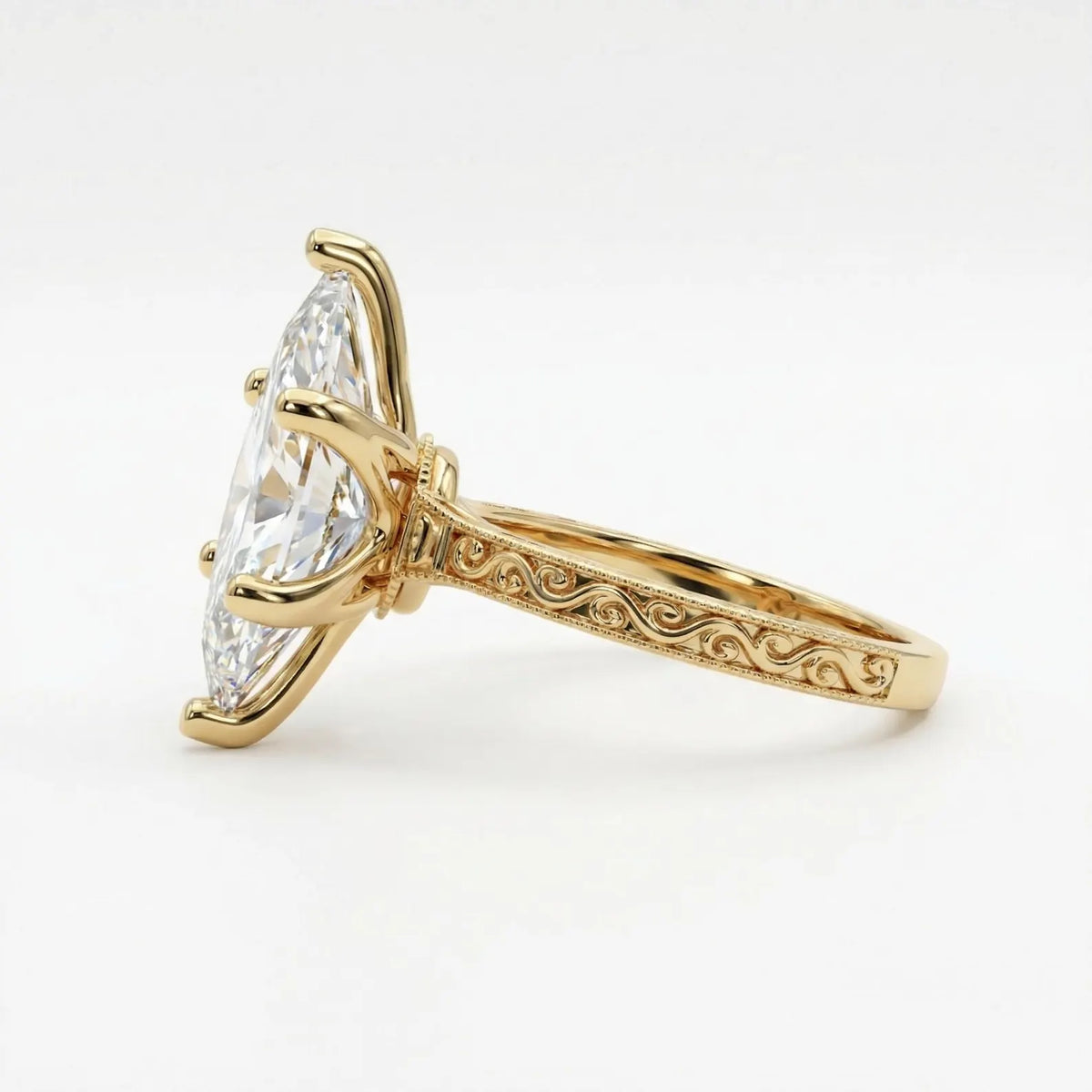 Angled side view of a 4 carat marquise cut lab diamond solitaire ring displaying carved scroll pattern with milgrain edges.