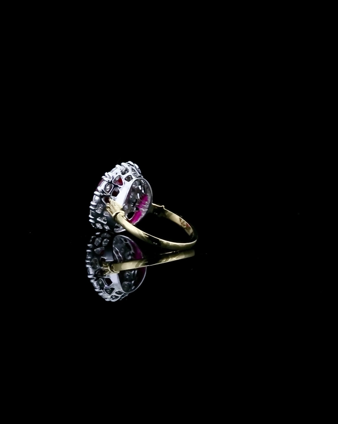 side-profile-angle-of-3-ct-red-oval-cut-moissanite-halo-ring-with-two-tone-band