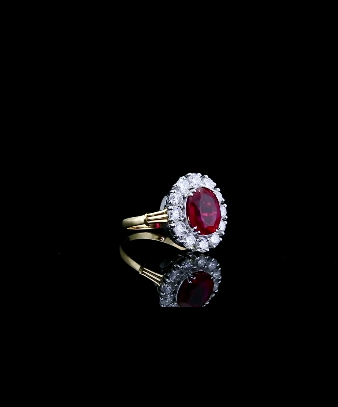 top-angled-view-displaying-vibrant-red-oval-center-stone-and-diamond-halo
