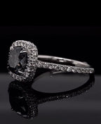 Angled view showing the sparkling double halo of the grey cushion moissanite ring.