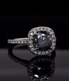 Top-down view of a 3 carat grey cushion cut moissanite diamond ring.