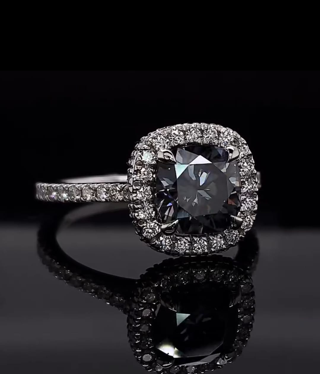 Top-down view of a 3 carat grey cushion cut moissanite diamond ring.