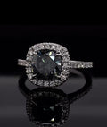 Close up of the brilliant facets on a 3 CT grey cushion cut moissanite stone.