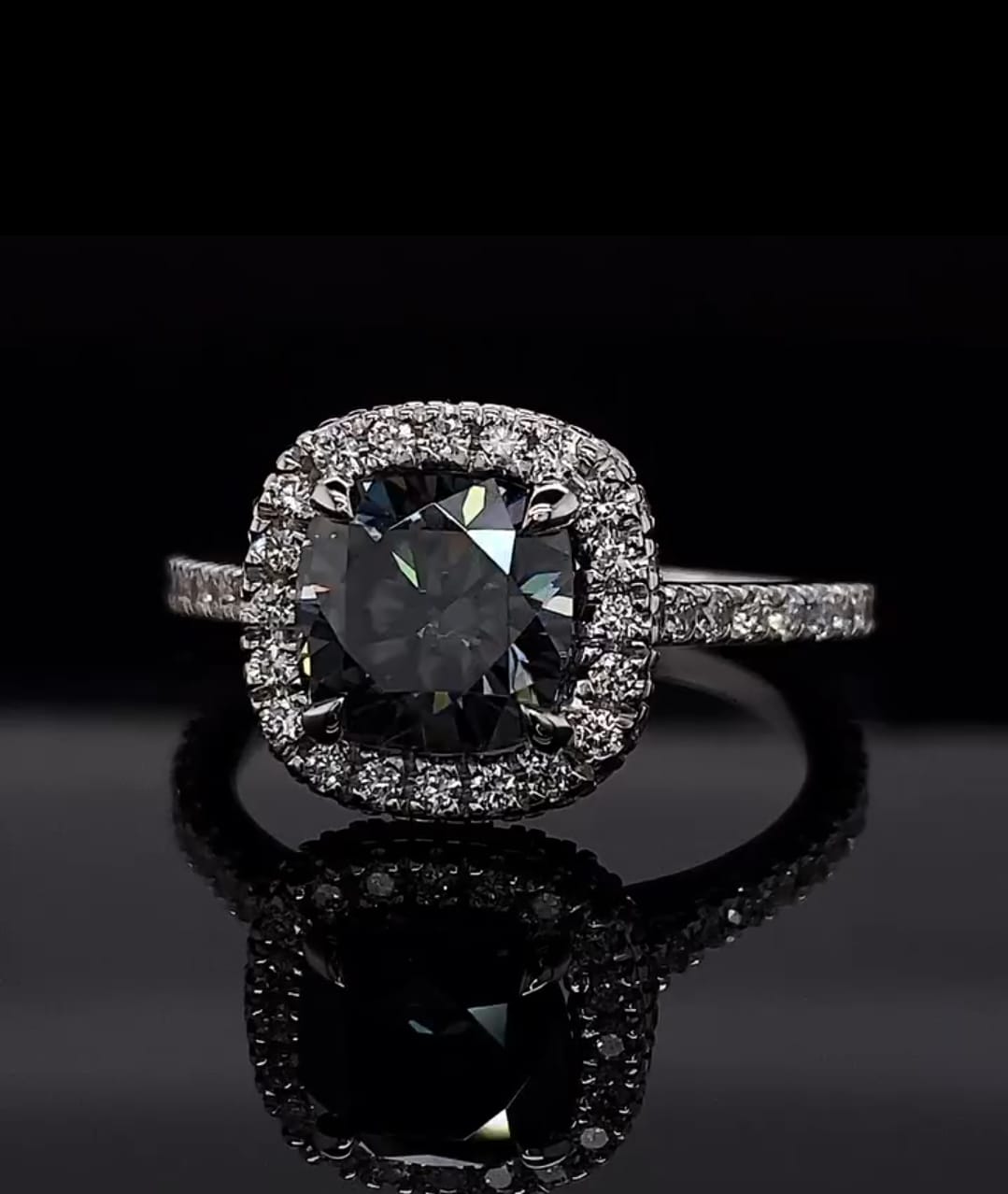 Close up of the brilliant facets on a 3 CT grey cushion cut moissanite stone.