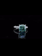 top-down-macro-shot-displaying-facets-of-4-carat-green-cushion-moissanite-ring