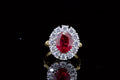 top-down-view-displaying-vibrant-red-oval-center-stone-and-diamond-halo