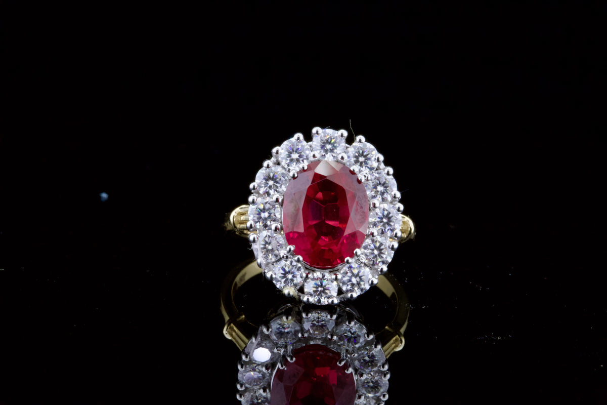 top-down-view-displaying-vibrant-red-oval-center-stone-and-diamond-halo