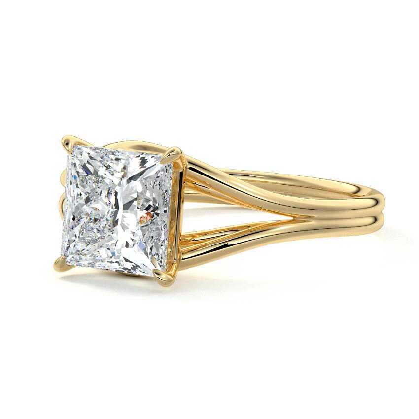 Side angled perspective view of a 3 CT princess cut lab diamond engagement ring in yellow gold with split shank.