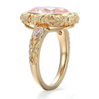 Side profile view showing hand-carved floral bezel halo and pear side diamond setting on a yellow gold engagement ring.