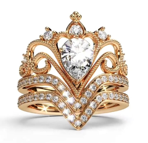 Direct front view showing the symmetrical crown tiara ring design, teardrop center stone, and double V-shaped diamond bands.