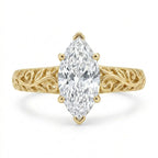 Direct top-down view of a 3 CT marquise cut lab grown diamond ring with vintage leaf filigree band in yellow gold.