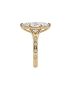 Side profile view of a 4 CT marquise cut lab diamond engagement ring showing starburst engraved band and milgrain basket rim.
