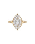 Top-down view of a 4 CT marquise cut lab grown diamond ring with star-set accent diamonds on yellow gold band.