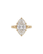 Direct top-down view of a 4 CT marquise cut lab grown diamond solitaire engagement ring on a plain yellow gold band.
