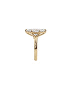Side profile view showing smooth yellow gold band and fine milgrain gallery rim on a 4 CT marquise lab diamond ring.