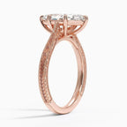 Perspective view of a 3 carat marquise cut lab diamond engagement ring with vintage hand engraving in rose gold.