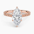 Top-down view displaying a 3 CT marquise lab grown diamond set in 6 prongs on a rose gold engraved band.