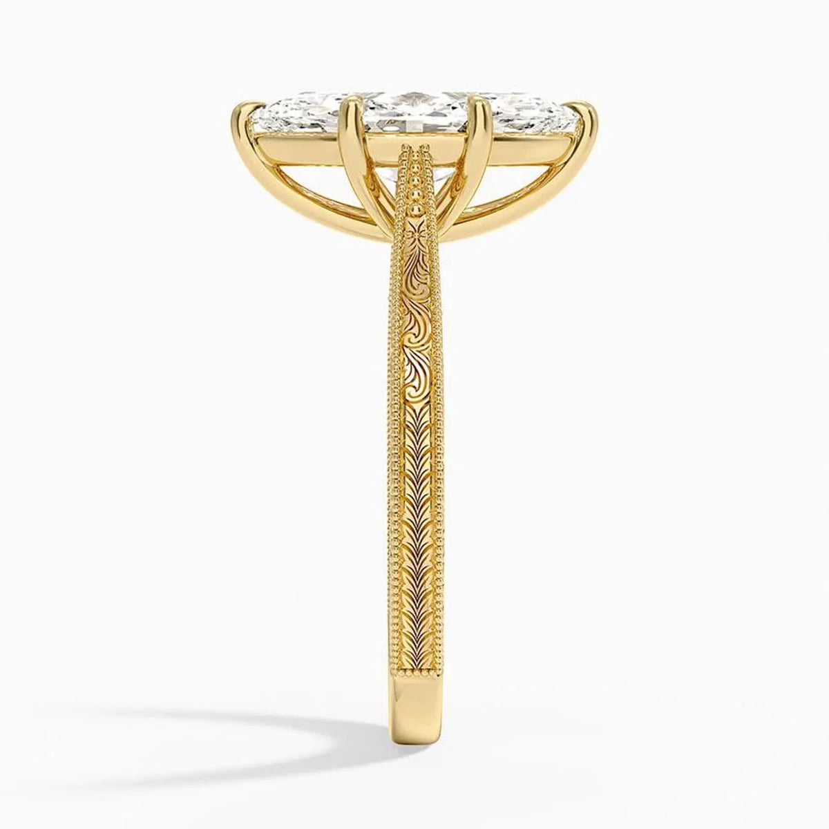 Side profile view showing intricate scrollwork engraving and milgrain detailing on a 14K yellow gold engagement ring band.
