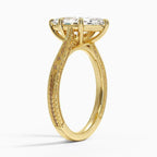 Perspective angled view of a 3 carat marquise cut lab grown diamond engagement ring with hand engraving in yellow gold.