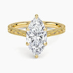 Direct top-down view of a 3 CT marquise cut lab grown diamond solitaire ring on an engraved yellow gold band.