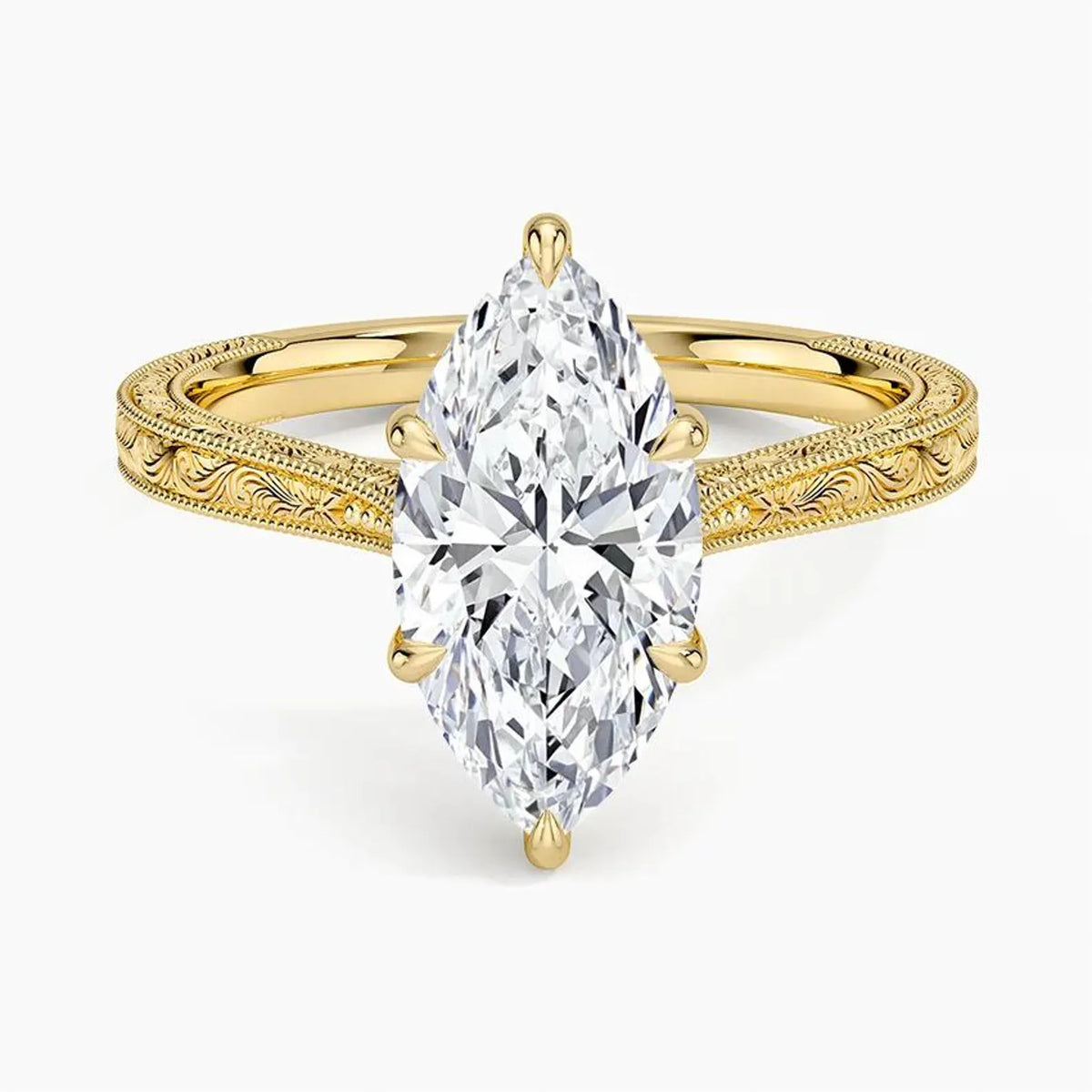 Direct top-down view of a 3 CT marquise cut lab grown diamond solitaire ring on an engraved yellow gold band.