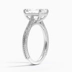 Perspective view of a 3 CT emerald cut lab diamond engagement ring with vintage hand engraving in white gold.