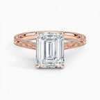 Top-down view displaying a 3 CT emerald cut lab diamond set in 4 prongs on a rose gold engraved band.