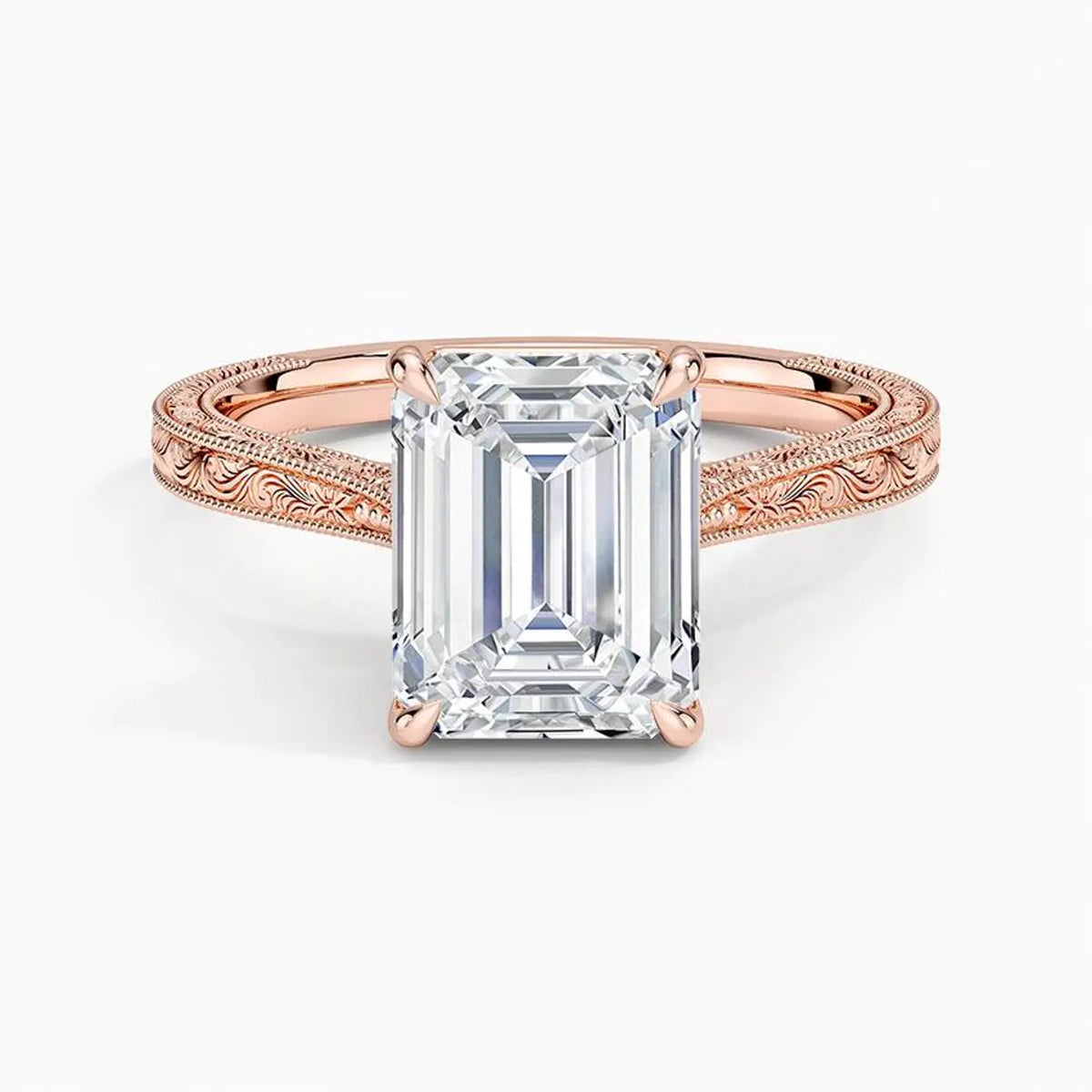 Top-down view displaying a 3 CT emerald cut lab diamond set in 4 prongs on a rose gold engraved band.